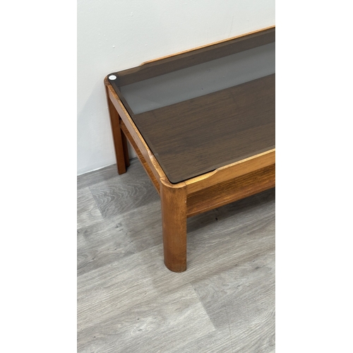 77 - A mid 20th century Myer teak and smoked glass coffee table - approx. 35cm high x 44cm wide x 87cm lo... 