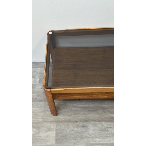 77 - A mid 20th century Myer teak and smoked glass coffee table - approx. 35cm high x 44cm wide x 87cm lo... 