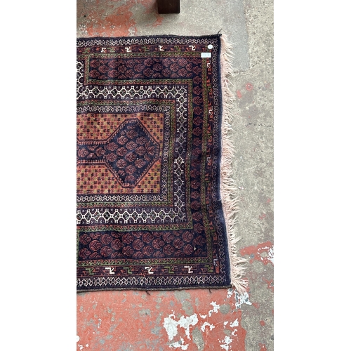 77A - A Persian hand knotted rug - approx. 160cm x 96cm