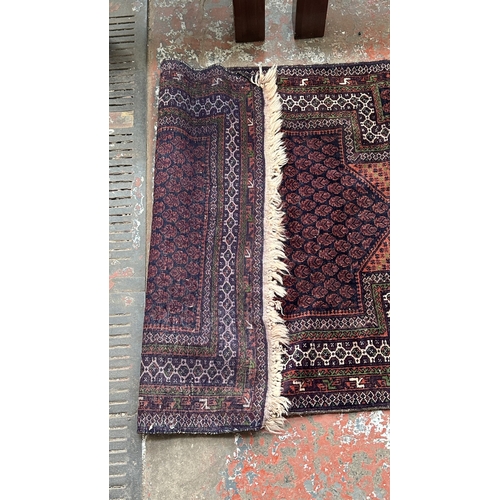 77A - A Persian hand knotted rug - approx. 160cm x 96cm