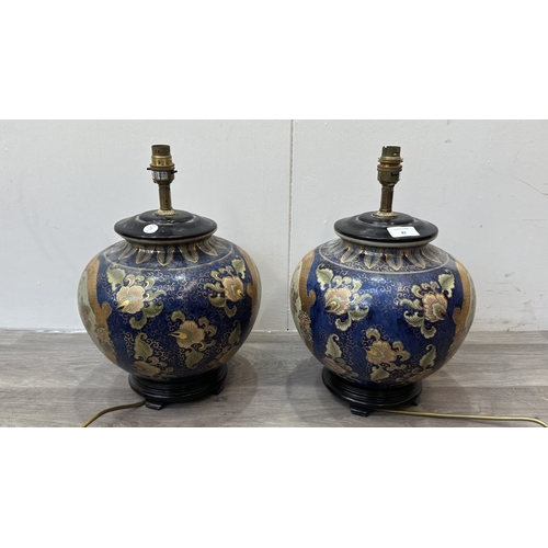 81 - A pair of Oriental hand decorated ceramic ginger jar table lamps on wooden plinths - approx. 37cm hi... 