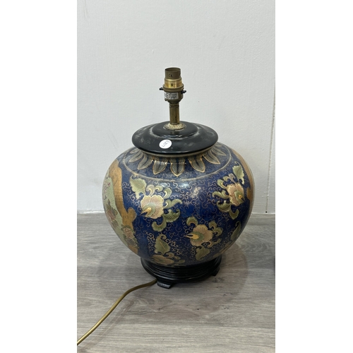 81 - A pair of Oriental hand decorated ceramic ginger jar table lamps on wooden plinths - approx. 37cm hi... 