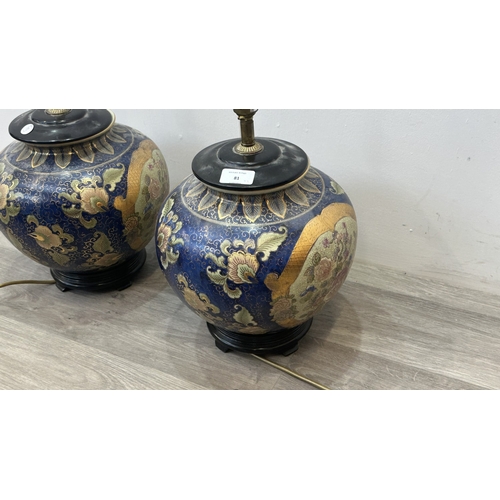 81 - A pair of Oriental hand decorated ceramic ginger jar table lamps on wooden plinths - approx. 37cm hi... 