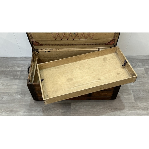 86 - A late 19th/early 20th century brown leather covered steamer trunk with wooden banding, metal decora... 