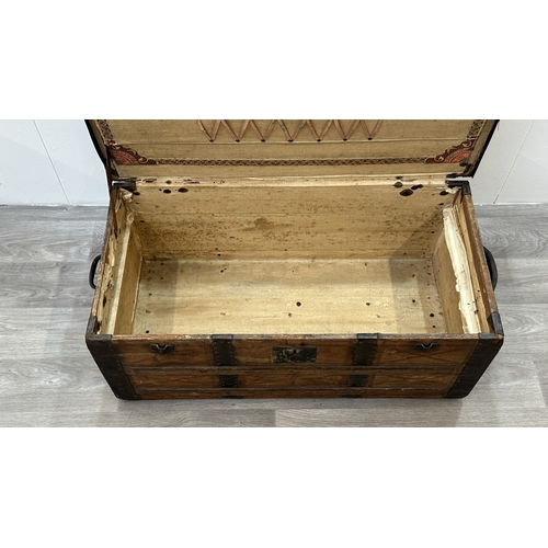 86 - A late 19th/early 20th century brown leather covered steamer trunk with wooden banding, metal decora... 