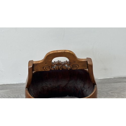 88 - A Chinese carved elm and gilt metal water bucket - approx. 45cm high x 38cm wide x 26cm deep