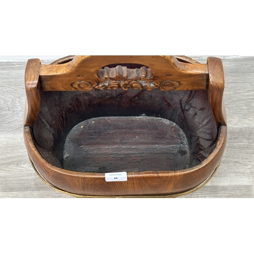 88 - A Chinese carved elm and gilt metal water bucket - approx. 45cm high x 38cm wide x 26cm deep