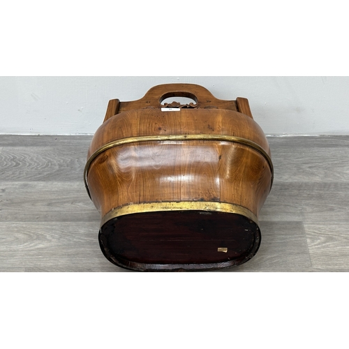 88 - A Chinese carved elm and gilt metal water bucket - approx. 45cm high x 38cm wide x 26cm deep