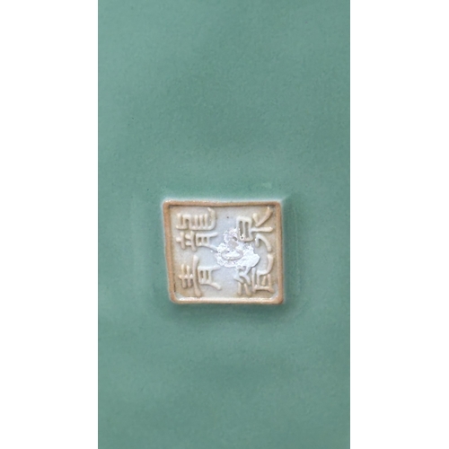 89 - A Chinese celadon glazed ceramic charger with dragon motif on carved wooden stand - approx. 50cm dia... 