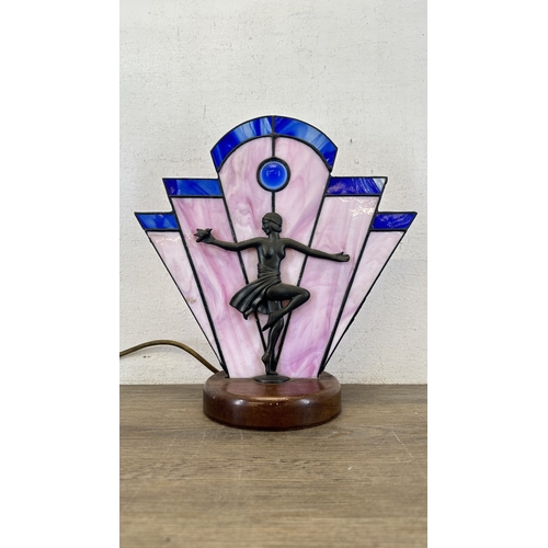 92 - An Art Deco style Tiffany type stained glass table lamp with cast metal flapper girl design on woode... 