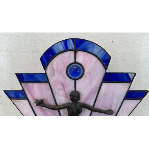 92 - An Art Deco style Tiffany type stained glass table lamp with cast metal flapper girl design on woode... 