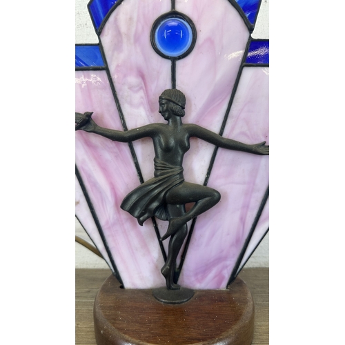 92 - An Art Deco style Tiffany type stained glass table lamp with cast metal flapper girl design on woode... 