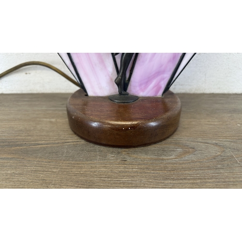 92 - An Art Deco style Tiffany type stained glass table lamp with cast metal flapper girl design on woode... 