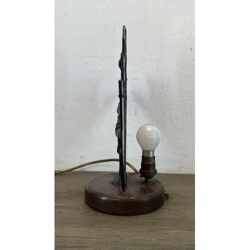92 - An Art Deco style Tiffany type stained glass table lamp with cast metal flapper girl design on woode... 
