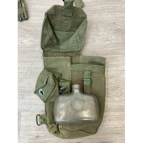 343 - Seven items to include cased WWII entrenching tool, WWII canvas gas mask bag containing pewter hip f... 