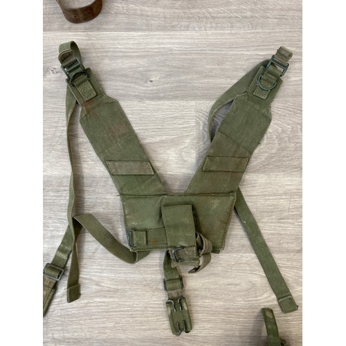 343 - Seven items to include cased WWII entrenching tool, WWII canvas gas mask bag containing pewter hip f... 