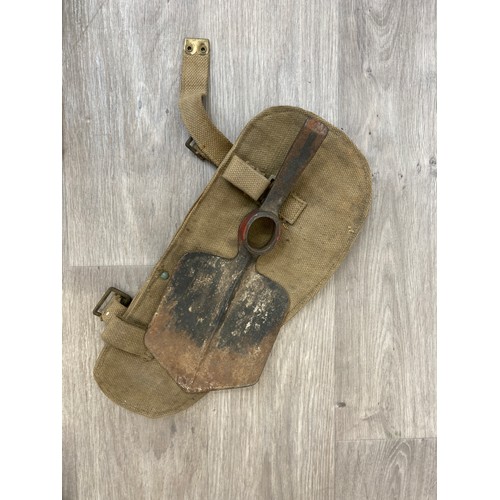 343 - Seven items to include cased WWII entrenching tool, WWII canvas gas mask bag containing pewter hip f... 