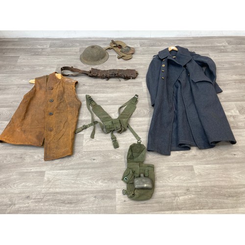 343 - Seven items to include cased WWII entrenching tool, WWII canvas gas mask bag containing pewter hip f... 