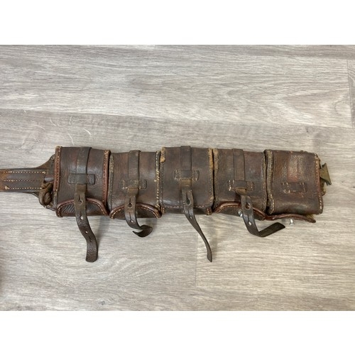 343 - Seven items to include cased WWII entrenching tool, WWII canvas gas mask bag containing pewter hip f... 