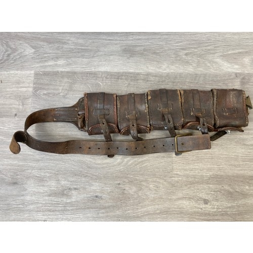 343 - Seven items to include cased WWII entrenching tool, WWII canvas gas mask bag containing pewter hip f... 