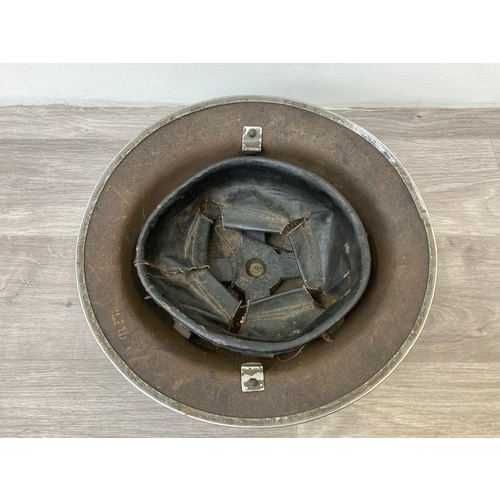 343 - Seven items to include cased WWII entrenching tool, WWII canvas gas mask bag containing pewter hip f... 