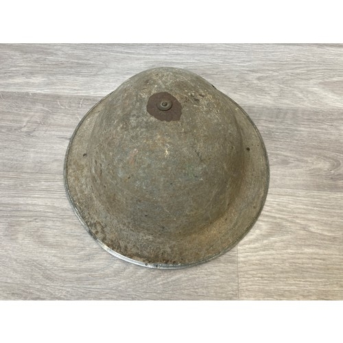 343 - Seven items to include cased WWII entrenching tool, WWII canvas gas mask bag containing pewter hip f... 