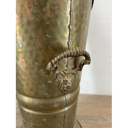 346 - A hammered brass coal scuttle with ceramic handle and three fireside accessories