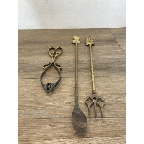 346 - A hammered brass coal scuttle with ceramic handle and three fireside accessories