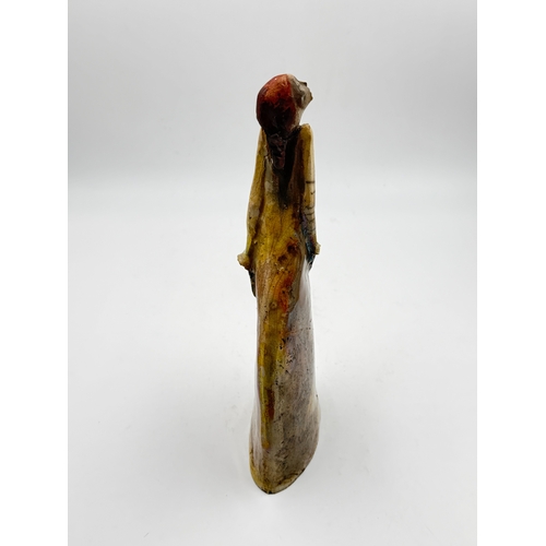 279 - A studio pottery figurine of an elongated women in the style of Marie-Madeleine Vitrolles, signed to... 