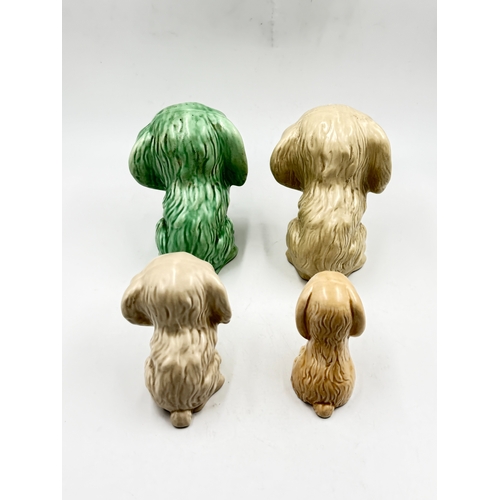 282 - Four mid 20th century Sylvac Sammy the Sad Dog figurines - largest approx. 15cm high