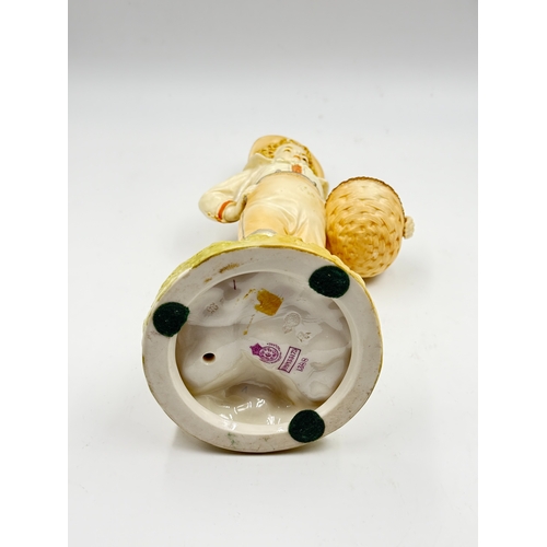 288 - A Royal Worcester hand painted porcelain figurine of a boy with basket by James Hadley, numbered 138... 