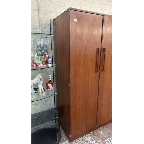 A mid 20th century Beautility teak double wardrobe with fitted interior ...