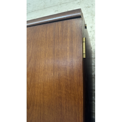 A mid 20th century Beautility teak double wardrobe with fitted interior ...