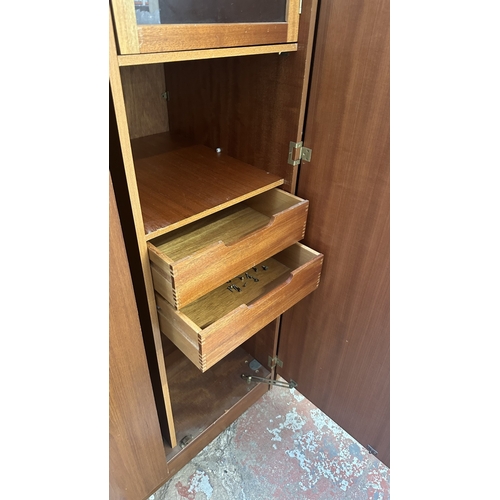 A mid 20th century Beautility teak double wardrobe with fitted interior ...