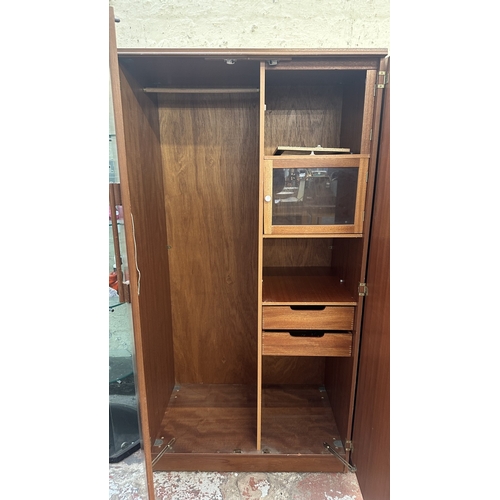 A mid 20th century Beautility teak double wardrobe with fitted interior ...