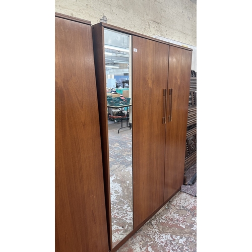 A mid 20th century Beautility teak double wardrobe with fitted mirror ...