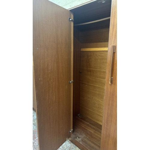 A mid 20th century Beautility teak double wardrobe with fitted mirror ...