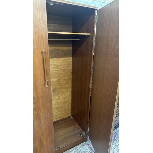 A mid 20th century Beautility teak double wardrobe with fitted mirror ...