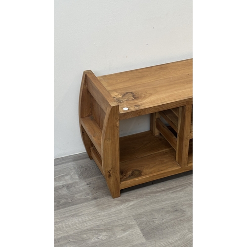 121 - An Indonesian suar wood TV stand - approx. 46cm high x 100cm wide x 32cm deep