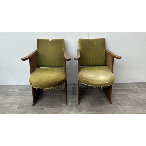 122 - A pair of Art Deco oak and green fabric upholstered armchairs with carved floral design, possibly by... 