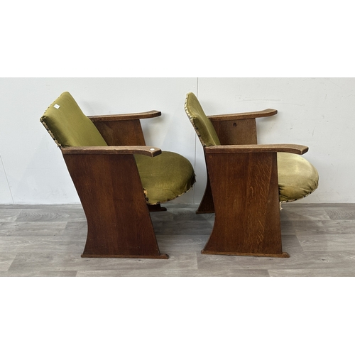 122 - A pair of Art Deco oak and green fabric upholstered armchairs with carved floral design, possibly by... 