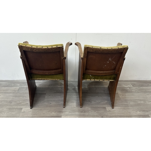 122 - A pair of Art Deco oak and green fabric upholstered armchairs with carved floral design, possibly by... 
