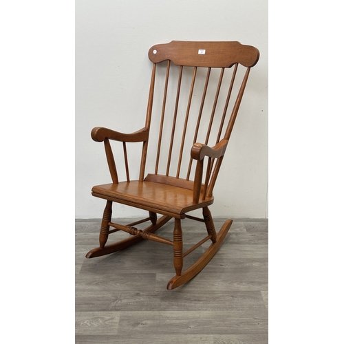 123 - A mid 20th century beech spindle back farmhouse rocking chair - approx. 102cm high x 60cm wide x 73c... 