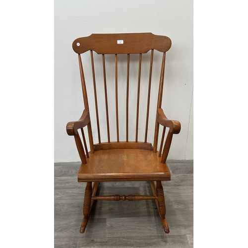 123 - A mid 20th century beech spindle back farmhouse rocking chair - approx. 102cm high x 60cm wide x 73c... 