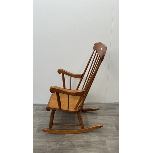 123 - A mid 20th century beech spindle back farmhouse rocking chair - approx. 102cm high x 60cm wide x 73c... 