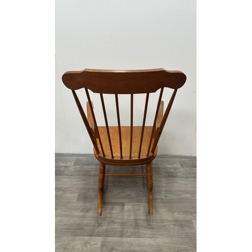 123 - A mid 20th century beech spindle back farmhouse rocking chair - approx. 102cm high x 60cm wide x 73c... 