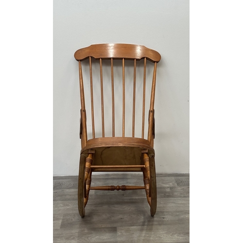 123 - A mid 20th century beech spindle back farmhouse rocking chair - approx. 102cm high x 60cm wide x 73c... 