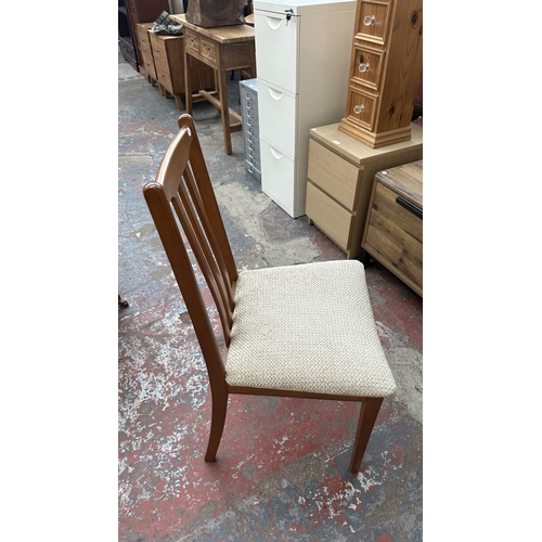 127 - A mid 20th century teak effect and beech drop leaf gate leg dining table and four fabric upholstered... 