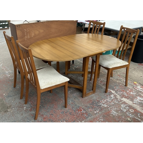 127 - A mid 20th century teak effect and beech drop leaf gate leg dining table and four fabric upholstered... 