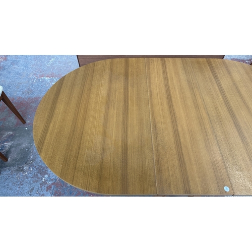 127 - A mid 20th century teak effect and beech drop leaf gate leg dining table and four fabric upholstered... 